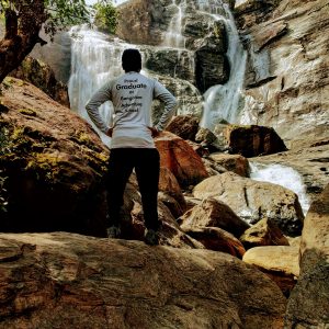 Guy Standing near Waterfall - Proud Graduate T-shirt